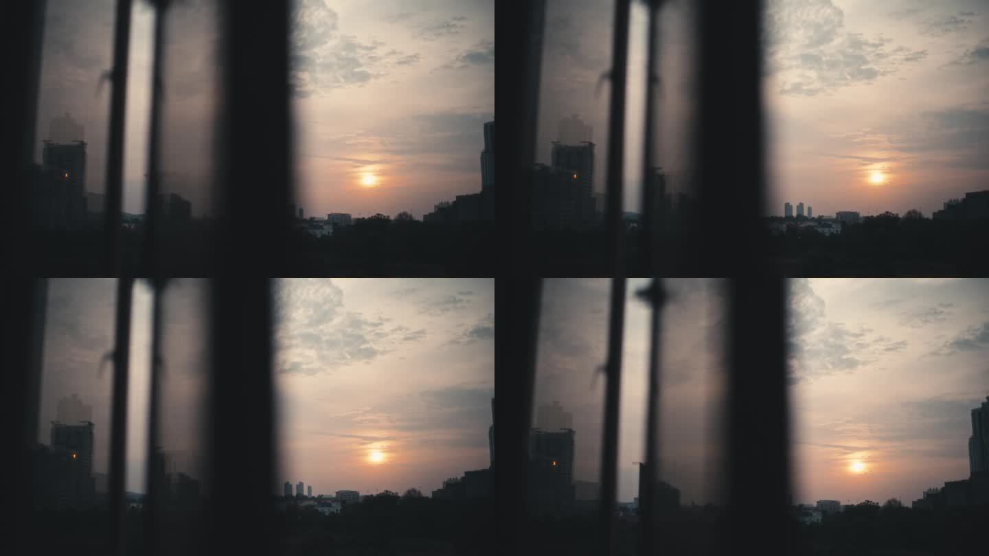 日落透过窗户看城市，反射在夕阳的窗户上