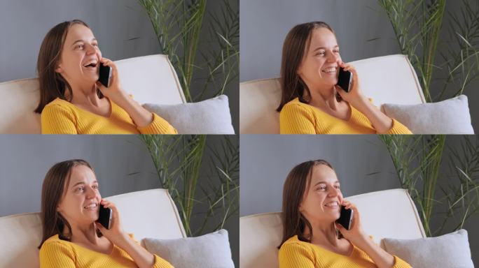 快乐美丽的白人女性参与愉快的智能手机通话与朋友分享讨论生活新闻，笑与积极的面部表情，分享八卦。