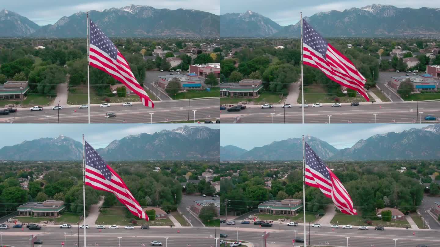 在日落前的一个夏夜，无人机在犹他州桑迪市拍摄了一面飘扬的美国国旗