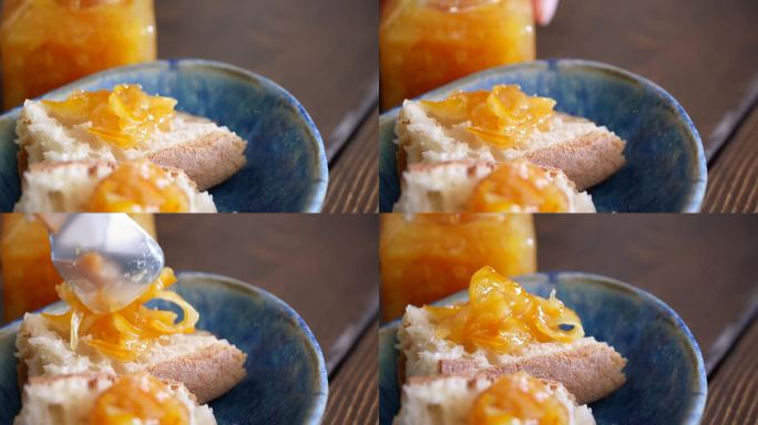 把柑橘果酱涂在法棍面包上的视频。