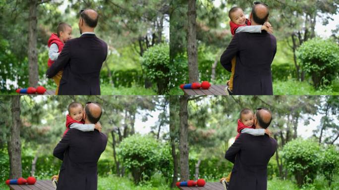 可爱的男孩拥抱他的父亲