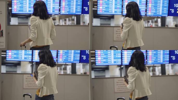 年轻的亚洲商务女性在国际机场候机楼门口检查商务旅行计划和航班时间表，确认与同事的会议文件。