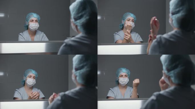 女外科医生一边洗手一边照镜子