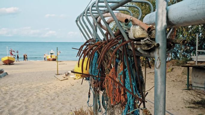 锈迹斑斑的金属钩、浮标、网、绳、海渔具悬挂在海滨滩港