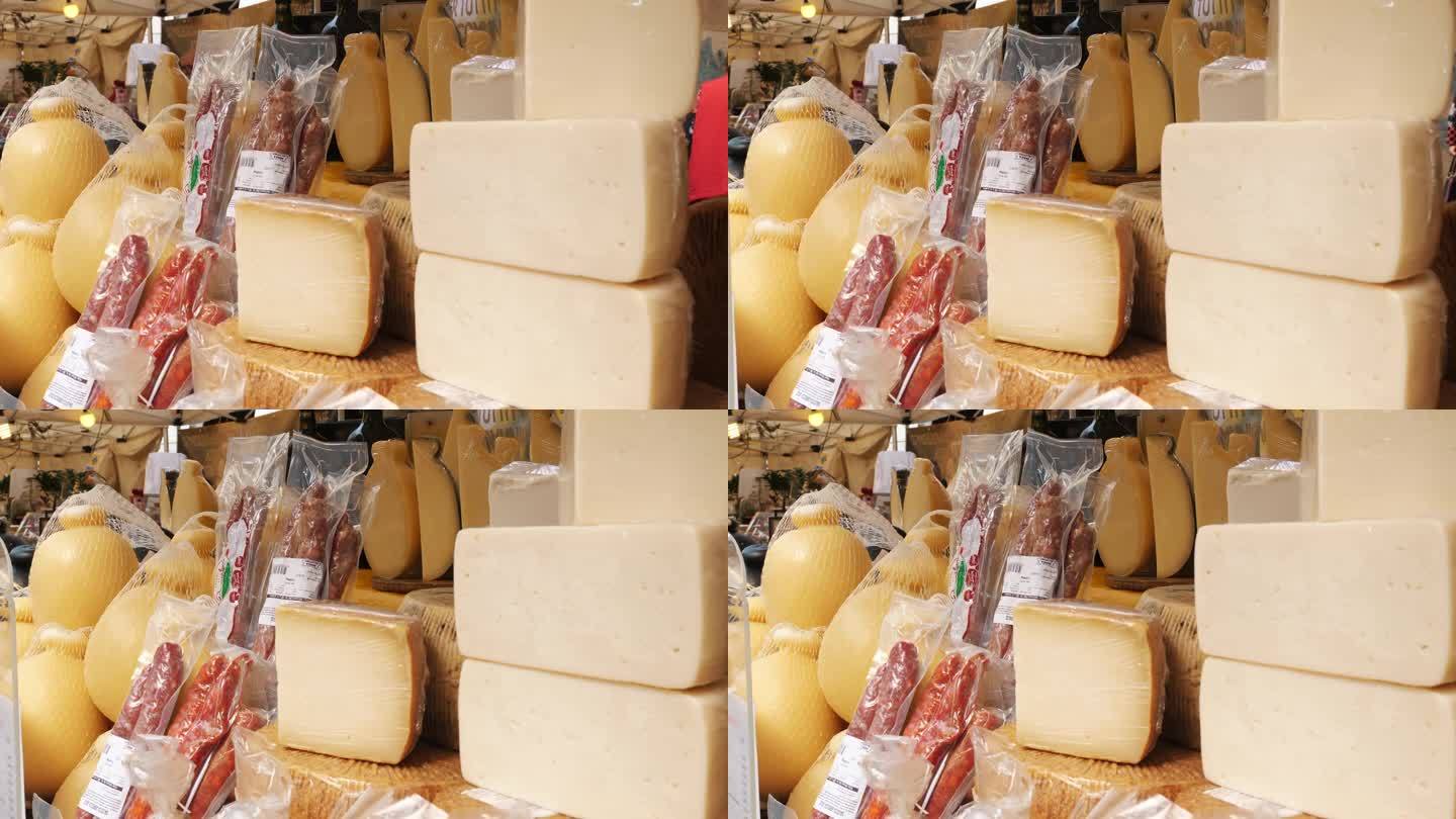 奶酪头。不同种类的自制硬奶酪。街头食品。美食节。奶酪制品零售。山羊奶酪，有机硬奶酪，帕尔马干酪。街头