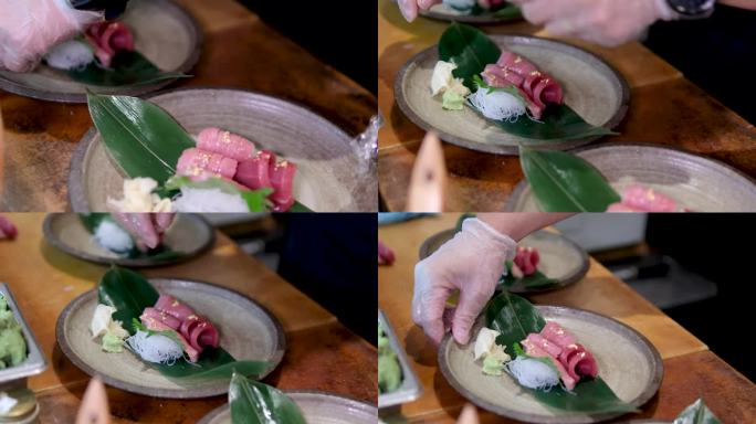 金枪鱼鱼肉米饭粉丝铺在床单上洒上酱汁男性双手戴手套厨师在餐厅寿司屋智能手表在手准备一道菜昂贵的亚洲菜
