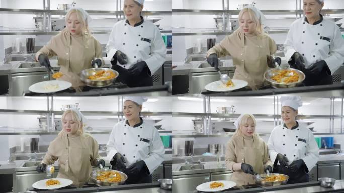 身着烹饪服，头戴白色烹饪帽的亚洲专业厨师在课堂上学习烹饪过程中微笑着为他的烹饪学生感到骄傲。在现代厨