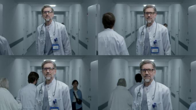 成熟的医生站在诊所走廊里，看着镜头