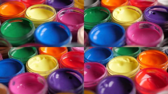设置水粉颜料在罐子明亮的颜色接近。一套多色水粉画在塑料罐上。多莉拍摄多色背景。多色涂料的背景。创意绘