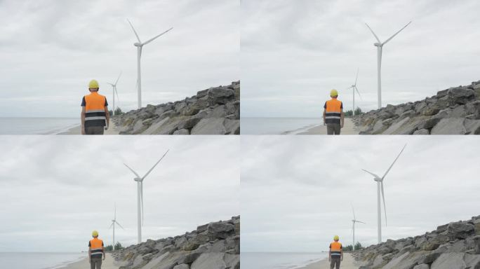 泰国南部，一名工程师正在使用数字平板电脑检查海上风力涡轮机农场的指令。风力发电机组，绿色能源，环境可