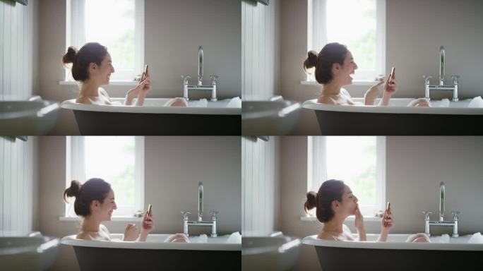 美女躺在泡泡浴里，用智能手机摄像头和家里的朋友视频聊天
