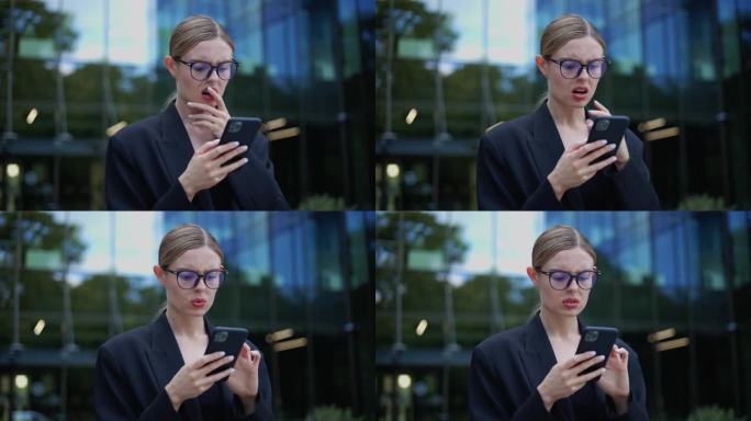 优雅的商务女性站在户外读着智能手机上可怕的消息，因为收到可怕的坏消息而感到不愉快的负面情绪。女女孩在