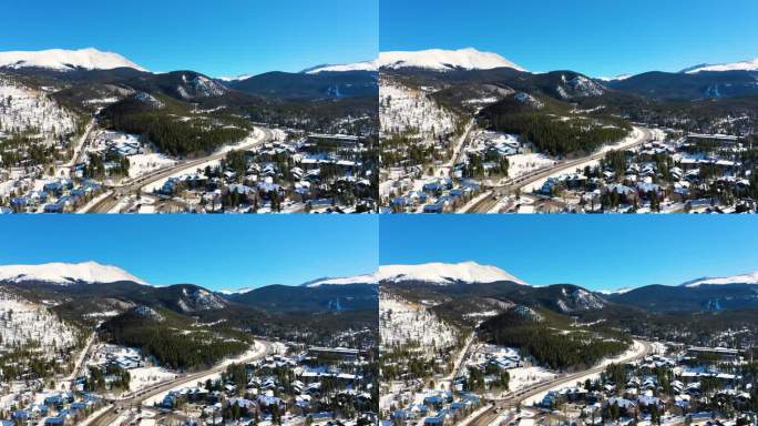 华丽的布雷肯里奇科罗拉多山城，白雪覆盖的房屋和人们在松树林的道路上开车，无人机视图