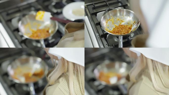 在餐厅的厨房里，妇女用平底锅和铝锅准备黄色食物。技艺高超的女人戴着手套在煤气灶上用平底锅做饭。
