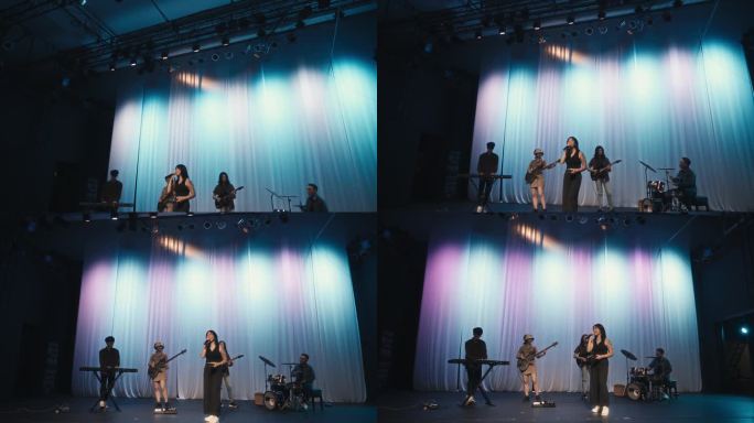 年轻的亚洲多种族组合女歌手现场乐队在舞台上表演