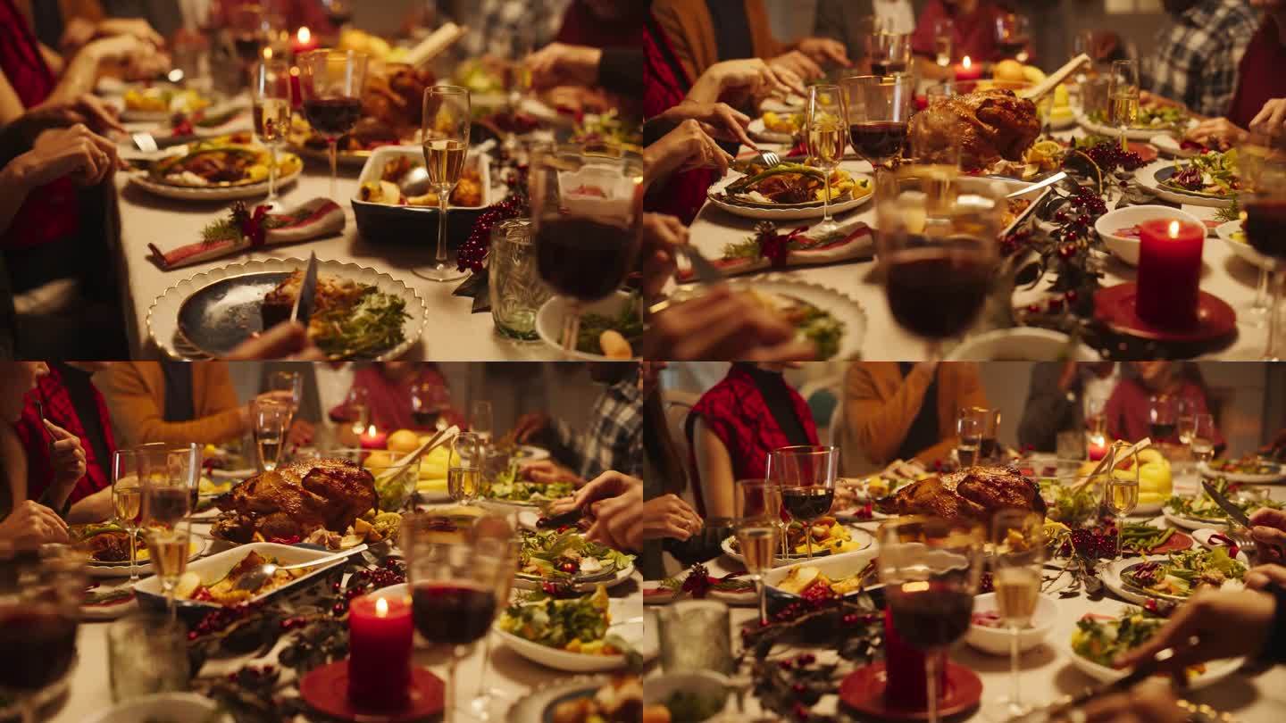 客人度过闲暇时间在家里的假期，享受美味的火鸡盛宴在餐桌后面。近距离拍摄一名成年男子享用庆祝大餐，在盘