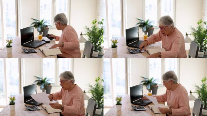 沉思的老妇人在家用笔记本电脑上网付账。资深女商人从事计算机工作。