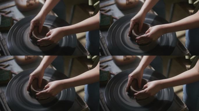 妇女用陶工的轮子制作陶器