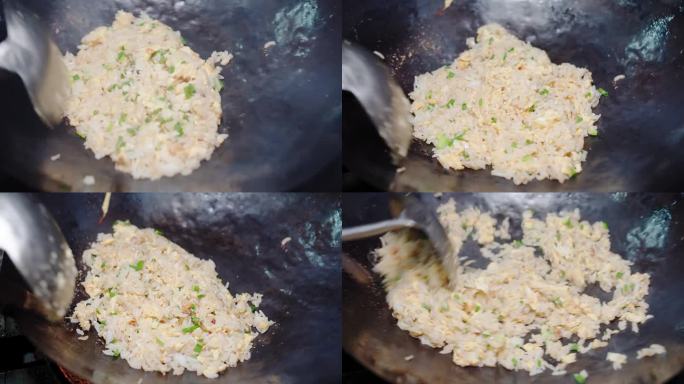 厨师准备烹饪泰国传统美食蟹肉炒饭和葱末在厨房的煎锅中搅拌