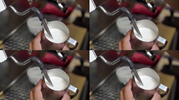 咖啡师用咖啡机泡牛奶，用来制作卡布奇诺或拿铁。用天然咖啡制作饮品的概念。