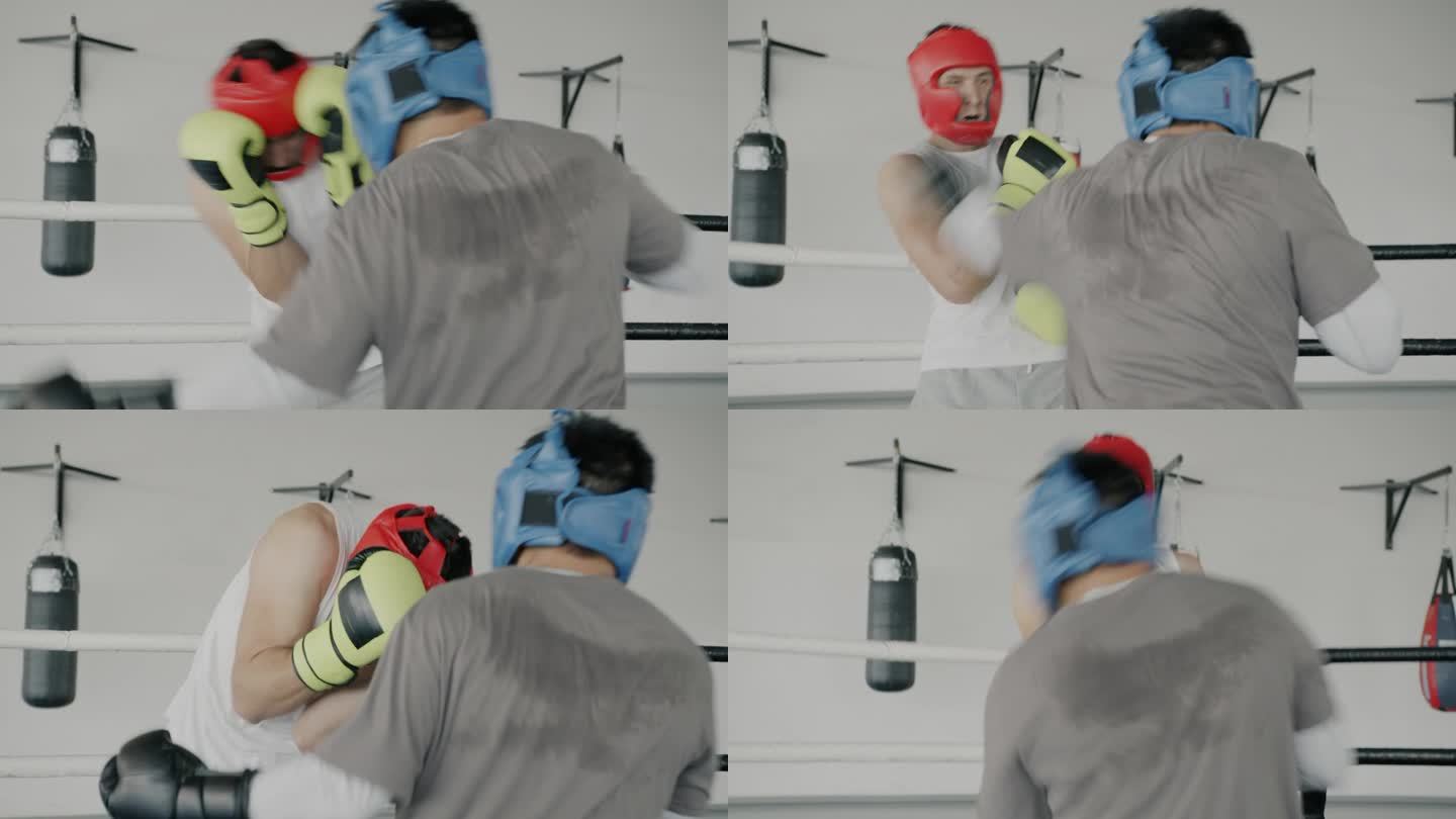 职业拳击手在体育中心的拳击场上训练，年轻人戴着防护头盔和手套出拳