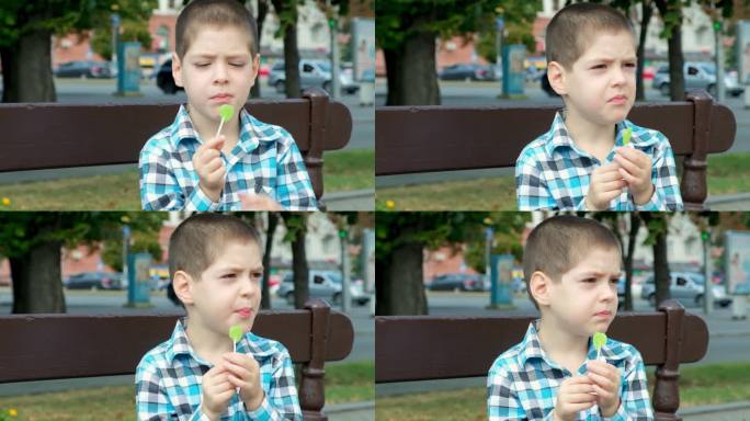 一个小男孩啃着棒棒糖，硬糖对孩子牙齿的危害