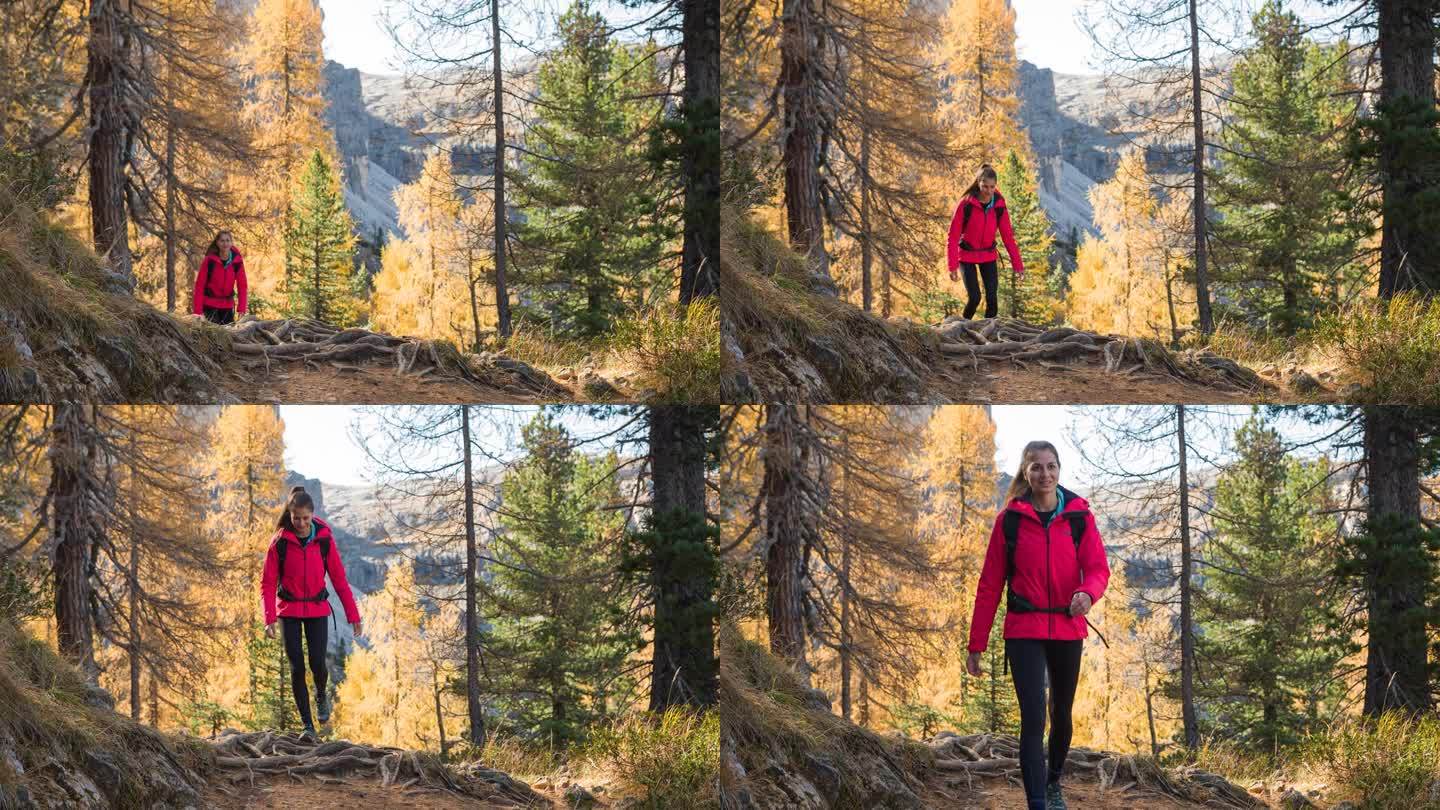 女徒步旅行者在群山中散步，周围是令人难以置信的秋景