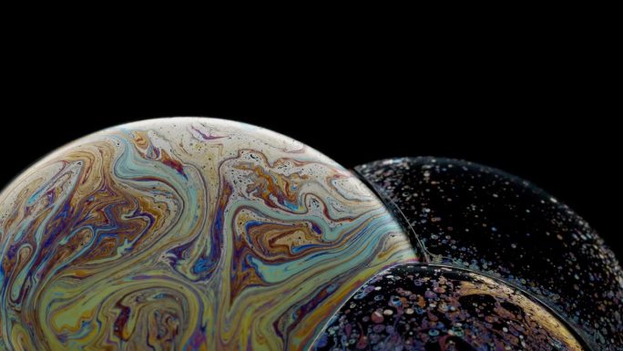 旋转的泡泡簇充满了五颜六色的图案，就像一个行星抽象的背景