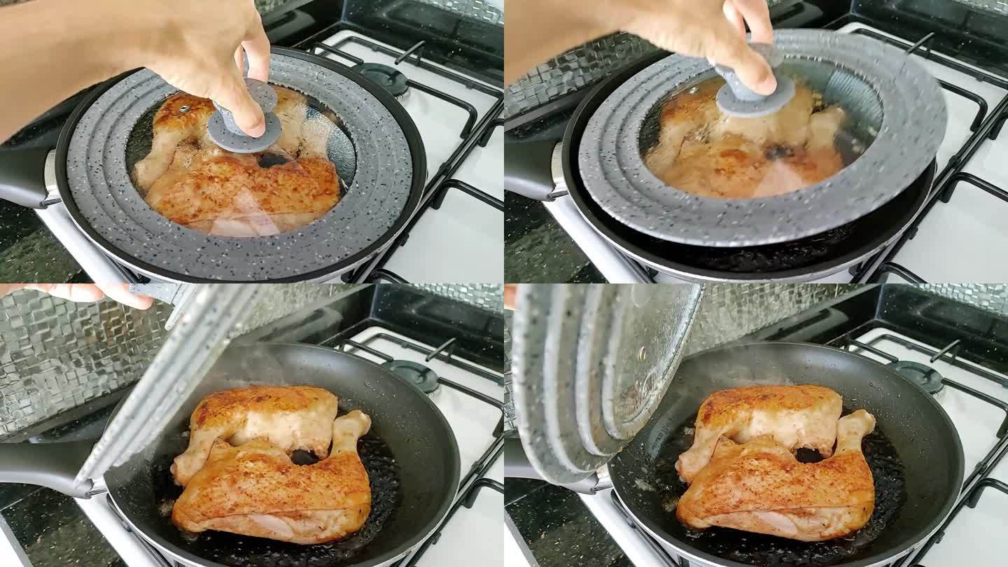 鸡腿在煎锅里煎，女人打开锅盖展示烤的过程。