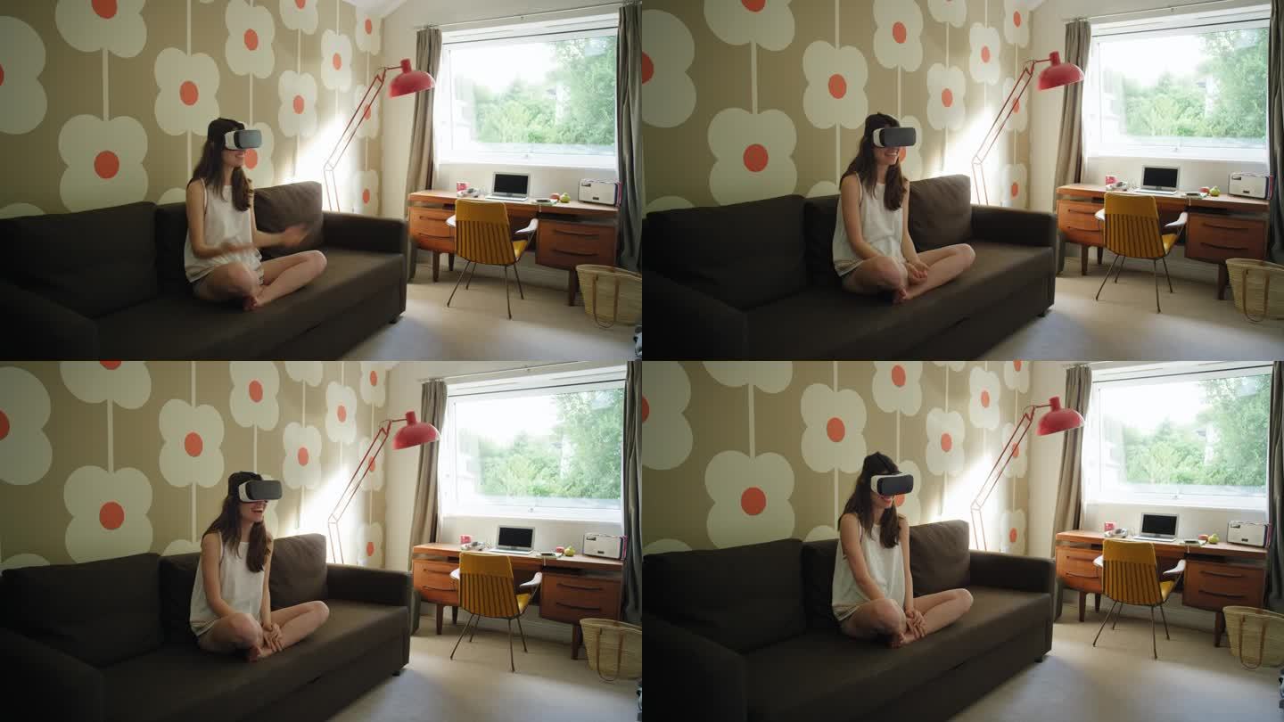 年轻女子戴着虚拟现实耳机坐在家里的沙发上观看360度视频想象概念
