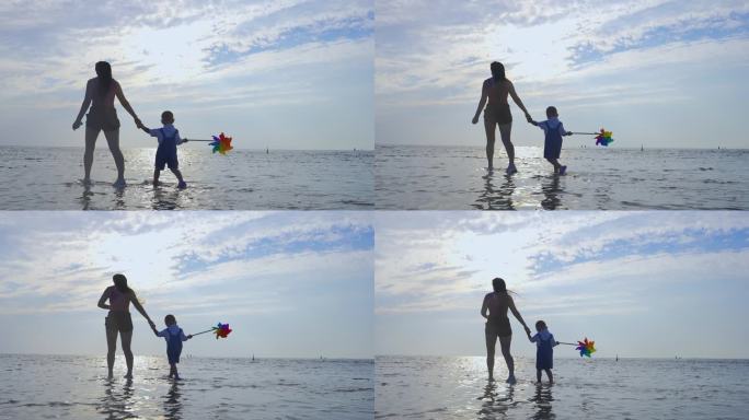 海边散步的母子风车男孩意境母子素材亲子爱