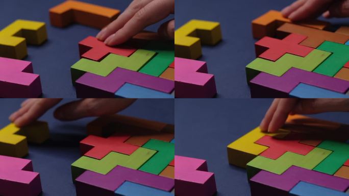 特写:慢镜头。手持木块拼图。木材立方体堆叠。复杂的概念和聪明的逻辑思维。