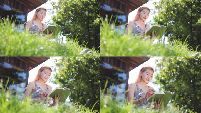迷人的年轻女子在花园里看书放松