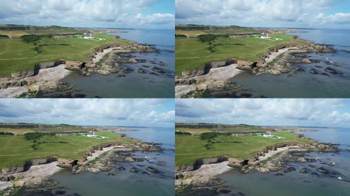 航拍无人机拍摄的南灯塔和海岸线桑德兰英格兰东北部。南希尔兹，马斯登和惠特本。无人机从左向右移动。4 