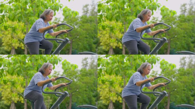 在公园健身站随意锻炼的亚洲老年妇女。代表以运动永葆青春，露天健身，身体健康的理念。城市公园户外健身器