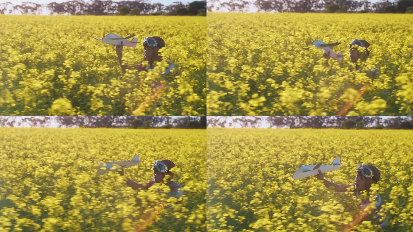 飞机，玩具和孩子在田野里奔跑，在乡下的油菜籽农场玩户外游戏。放飞飞机，梦想与孩子在鲜花中奔跑，暑假与
