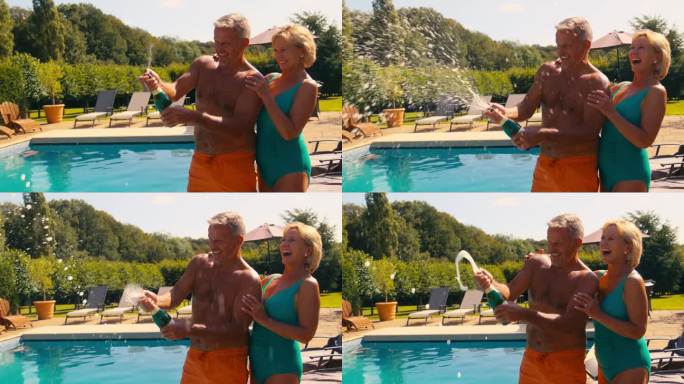 穿着泳装度假的老夫妇在泳池边开瓶喷香槟酒