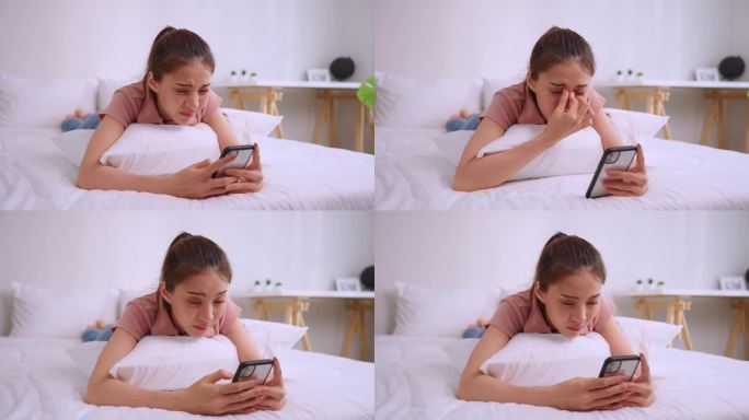 疲惫的亚洲年轻女子躺在床上玩手机伤了眼睛。有魅力的女孩坐在沙发上，感觉劳累过度的视觉疲劳和眼睛疲劳，