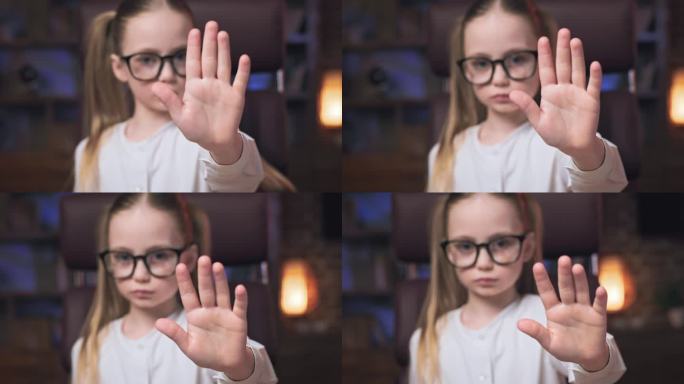 戴着眼镜的严肃小孩伸出手说不