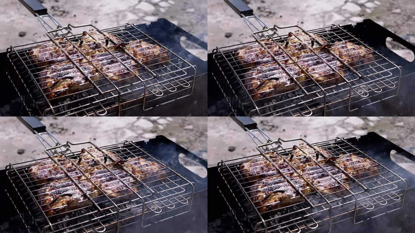 在烧烤架上准备多汁的肉，在阳光下的后院烧烤