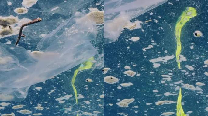 从水下看漂浮在海洋表面脂肪层的塑料碎片