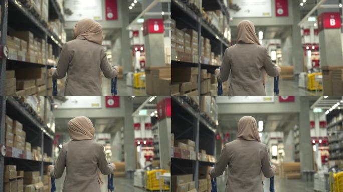 4K穆斯林妇女在仓库推着手推车