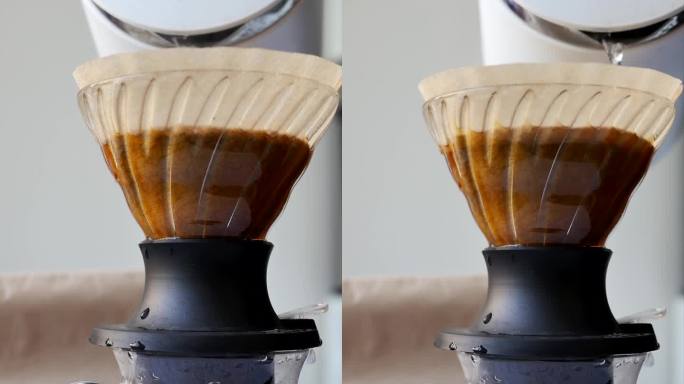 在烹饪过程中，将沸水倒入滴漏式咖啡机的漏斗杯过滤器的垂直视频。将热水倒入咖啡粉中冲泡天然咖啡