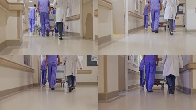 医护人员和医生在医院走廊推轮式病床的后视图