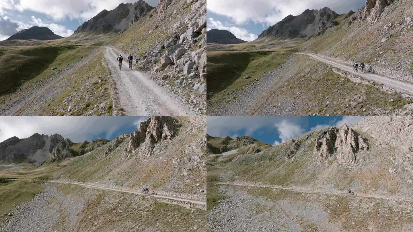 无人机拍摄的骑自行车者攀登高山的照片