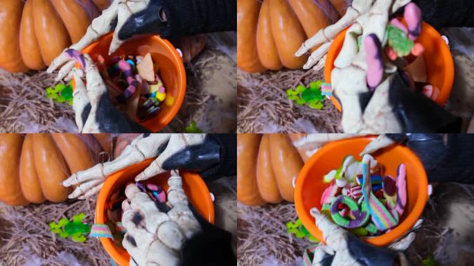 骷髅手在桶里展示彩色糖果，收集糖果玩不给糖就捣蛋，橘子南瓜，