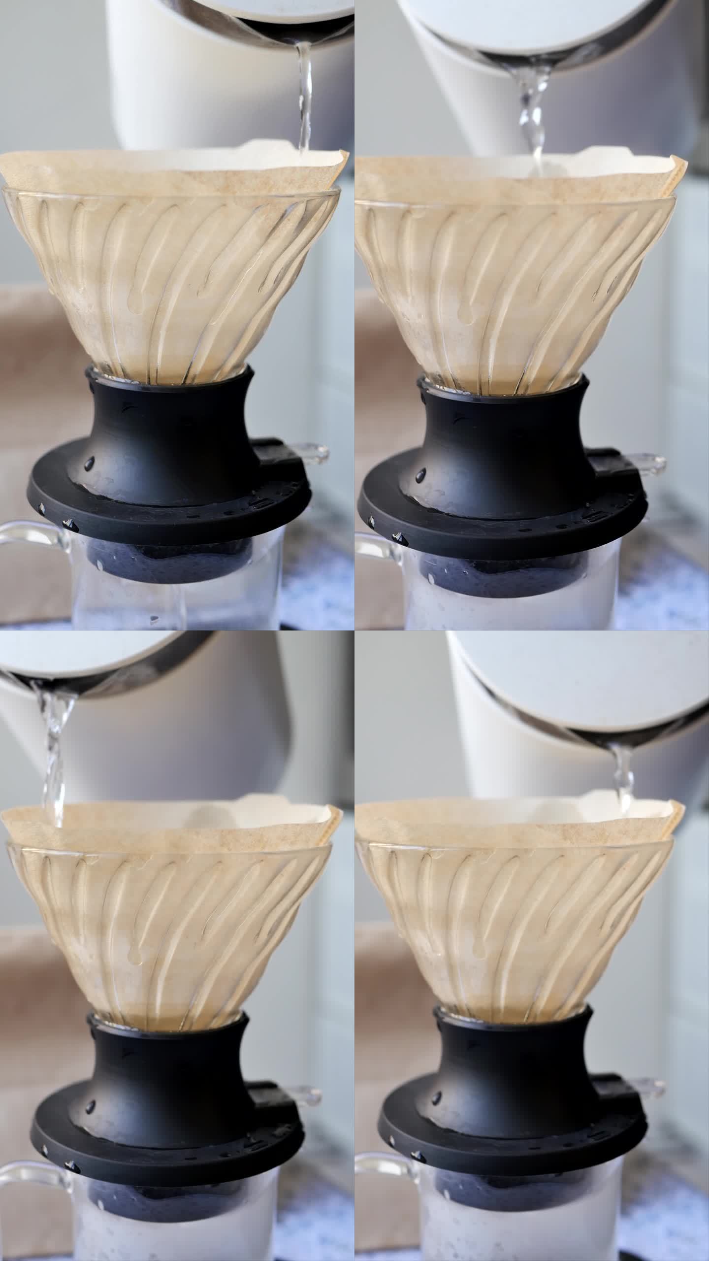 在用滴灌法制备饮料时，将热水倒入杯式滤纸上，使滤纸湿润的过程。另一种冲泡咖啡的方法。竖屏方向