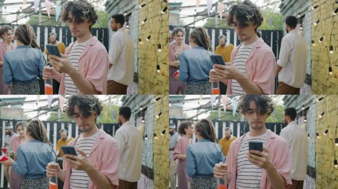 无忧无虑的家伙使用智能手机应用程序，并在咖啡馆的露天派对上与朋友跳舞