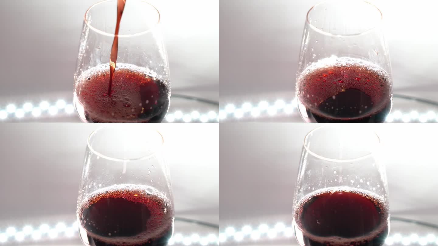 酒杯里盛满了溅起的红酒，溅起的红酒进入玻璃工作室拍摄