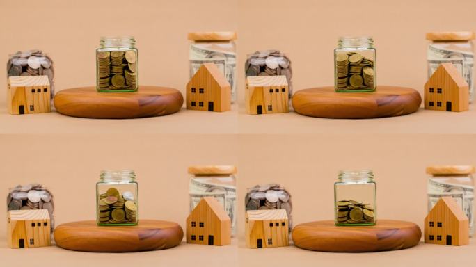 钱和房子存钱买房子建第一套房子现金贷款现金流住房贷款硬币在玻璃罐里定格录像投资增长